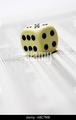 Dices lying on share price chart in a newspaper Stock Photo