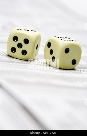 Dices lying on share price chart in a newspaper Stock Photo