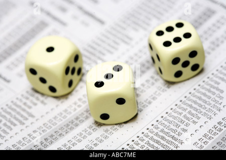 Dices lying on share price chart in a newspaper Stock Photo