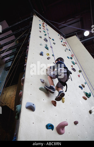 6 year old boy shows bravery and determination while climbing at challenging  indoor rock climbing facility, Model Released Stock Photo