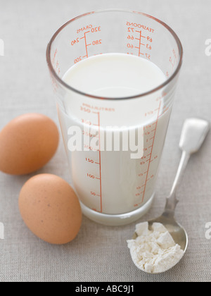 Milk in measuring jug with eggs and flour pancake making - high end Hasselblad 61mb digital image Stock Photo