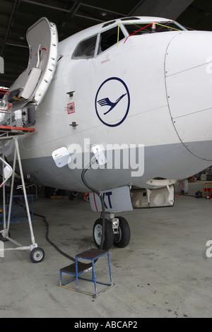 Boeing 737 jet airline airliner undergoing overhaul maintenance inspection in hangar Stock Photo