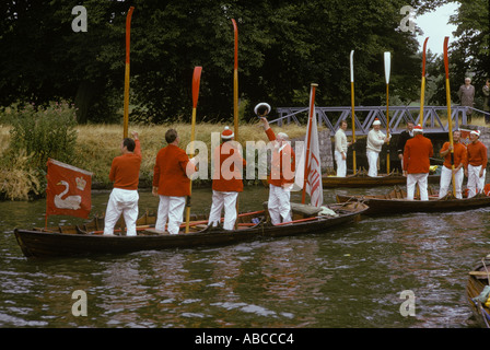 Swan Upping Vintners Company swan uppers standing up in their skiffs at Romney Lock, Windsor. The Queens Swan Marker, saluting the Queen. Berkshire. Stock Photo