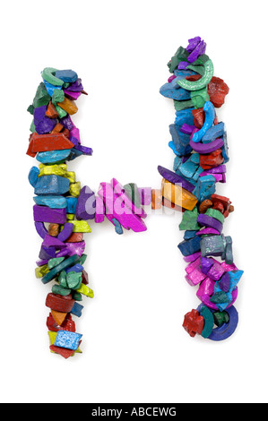 Letter H made from colourful textured magnetic rocks. Bright mosaic alphabet font isolated on a white background for design asset Stock Photo