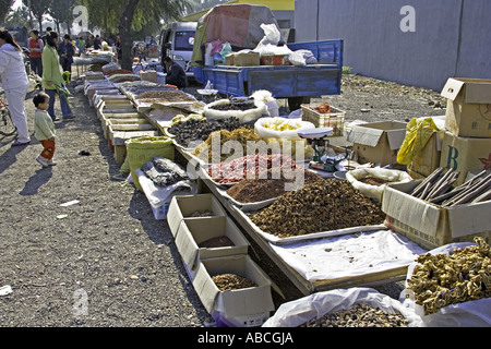 CHINA Beijing Wide variety of dried foods spices and snacks displayed for sale in open air roadside market Stock Photo