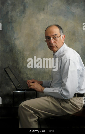 SSA70209 Old man Mr Narda working on laptop computer looking at the camera Stock Photo