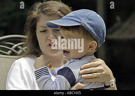 SOUTH CAROLINA ROCK HILL Two year old boy crying in his mother s lap with mother comforting him Stock Photo