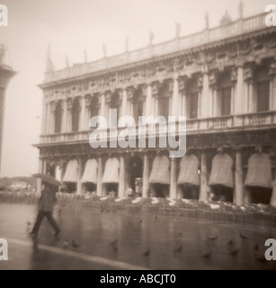 Woman walking in the rain, San Marco - Venice, Italy Stock Photo