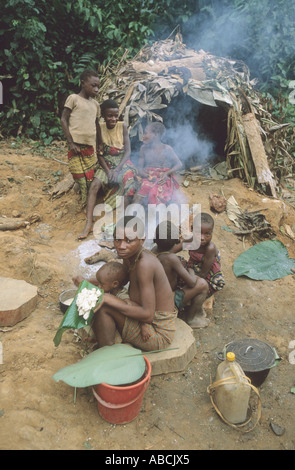 A Baka pygmy family by their temporary leaf houses in the rainforest of Rupublic of Congo close to the Cameroon border Stock Photo