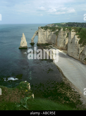 Sea cliff, rock needle and arch, wave cut notch at base of cliffs, wave cut platform, and pebble beach, Étretat, Normandy France Stock Photo