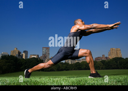 Man stretching in central park Stock Photo