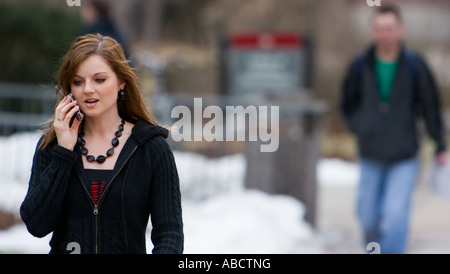A woman speaks on a mobile phone on the campus of the University of Nebraska in Lincoln, Nebraska. Stock Photo