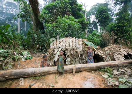 A Baka pygmy child by a temporary leaf houses in the rainforest of Republic of Congo close to the Cameroon border Stock Photo