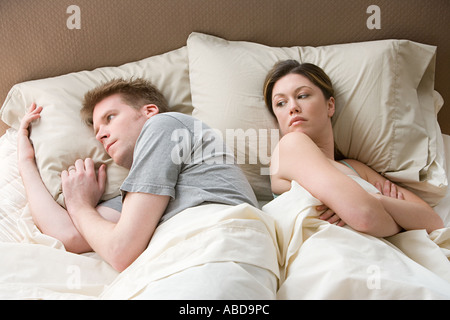 Hostile couple in bed Stock Photo