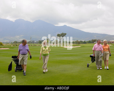 Senior couples on golf course Stock Photo