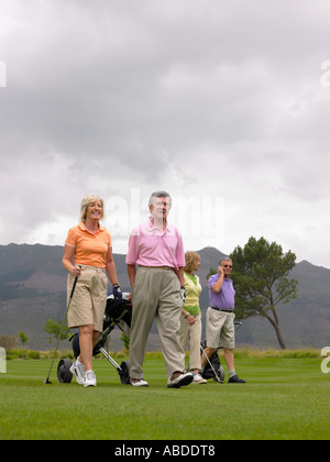Golfers walking on course Stock Photo