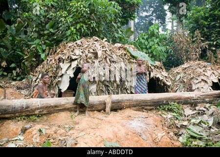 A Baka pygmy family by their temporary leaf houses in the rainforest of Rupublic of Congo close to the Cameroon border Stock Photo