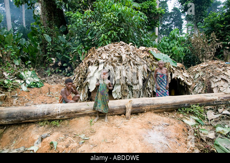 A Baka pygmy child by a temporary leaf houses in the rainforest of Republic of Congo close to the Cameroon border Stock Photo