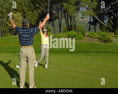 Couple playing golf Stock Photo