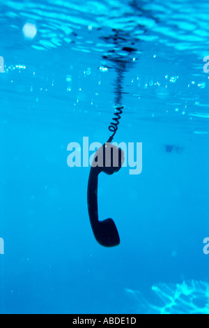 A telephone receiver in a swimming pool Stock Photo