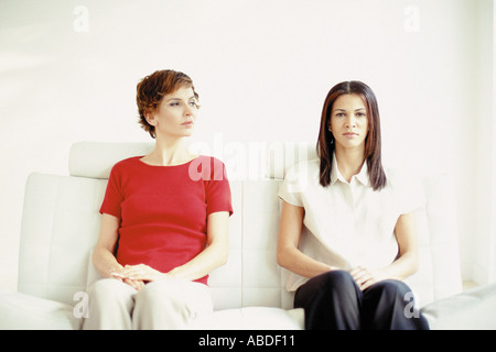 Two women sitting on a sofa Stock Photo