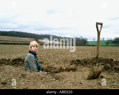 Farmer inside a hole Stock Photo