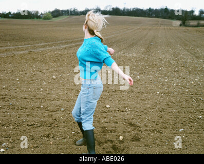 Woman dancing in a field Stock Photo