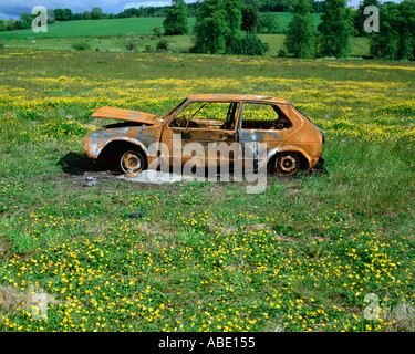Abandoned car in a field Stock Photo