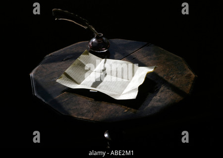 Ink well, quill and writing paper at Jane Austen;s writing desk Jane Austin House Museum Chawton near Alton Hampshire UK Stock Photo