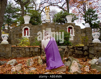 Jesus Statue praying at a replica of the Vatican gardens at a church in Bridgeport Connecticut Stock Photo