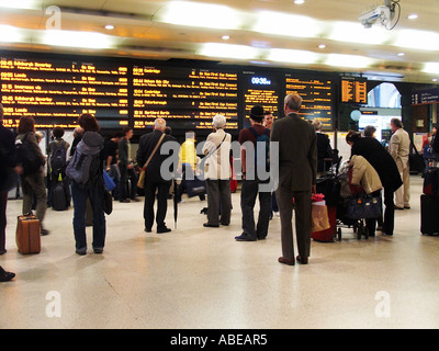 passengers at Kings Cross station checking the train times from the concourse. Stock Photo