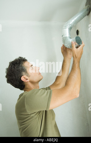 Man holding up pipe Stock Photo