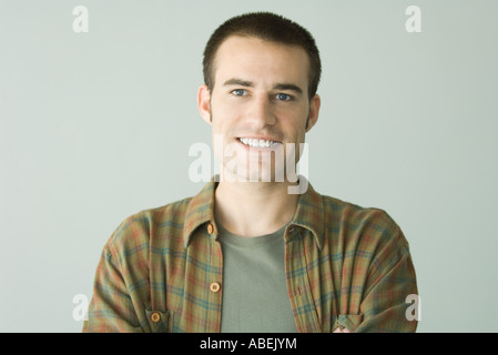 Man smiling at camera, front view, portrait Stock Photo