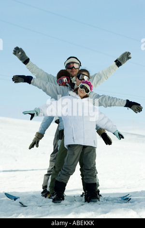 Young skiers with arms out, full length portrait Stock Photo