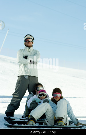 Young snowboarders on ski slope, full length portrait Stock Photo
