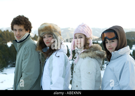 Young friends standing in snowy landscape, portrait Stock Photo