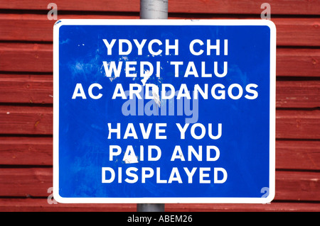 Bilingual Welsh English landuage HAVE YOU PAID AND DISPLAYED sign in pay and display cark park Mid Wales UK Stock Photo