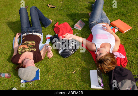 Cardiff University students relaxing & chatting on the lawn at the university while studying for exams Cardiff South Wales UK Stock Photo