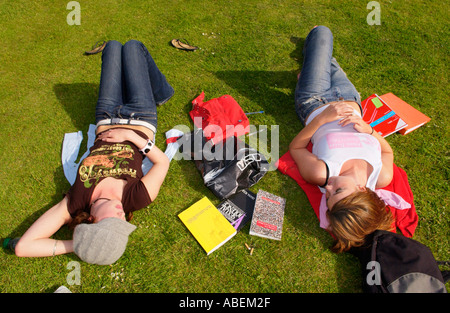 Cardiff University students relaxing & chatting on the lawn at the university while studying for exams Cardiff South Wales UK Stock Photo