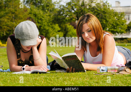 Cardiff University students relaxing & chatting on the lawn at the university while studying for exams Cardiff South Wales UK Stock Photo