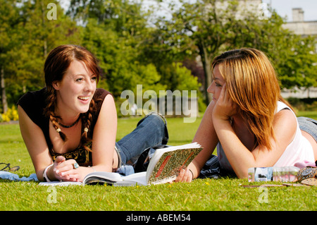 Cardiff University students relaxing & chatting on the lawn at the university while studying for exams Cardiff South Wales UK Stock Photo