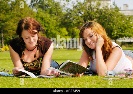 Cardiff University students relaxing & chatting on the lawn at the university while studying for exams Cardiff South Wales UK Stock Photo