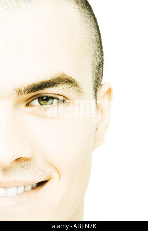 Young man smiling at camera, close-up Stock Photo