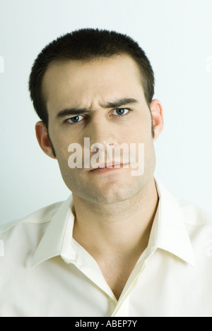 Man furrowing brow, portrait Stock Photo