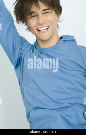 Young man jumping and smiling, portrait Stock Photo