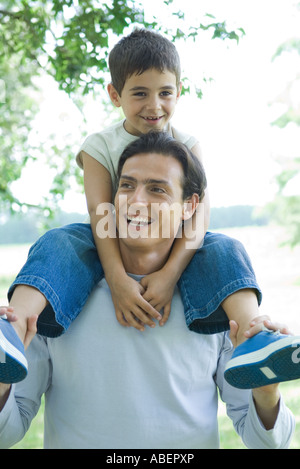 Boy and father, boy riding on man's shoulders Stock Photo