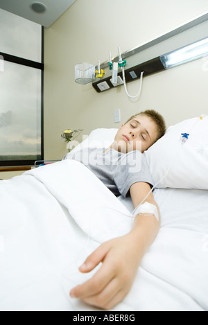 Boy lying in hospital bed Stock Photo