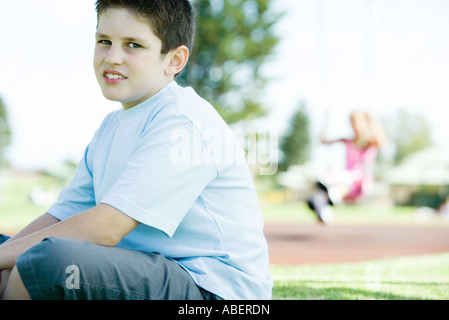 Child sitting on playground Stock Photo