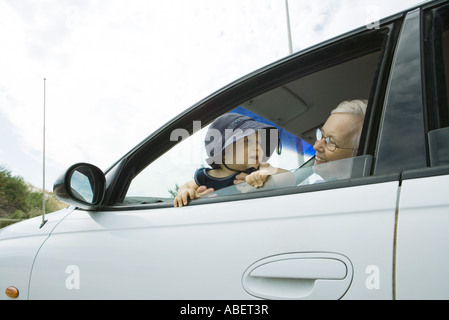 Senior woman and baby in car Stock Photo