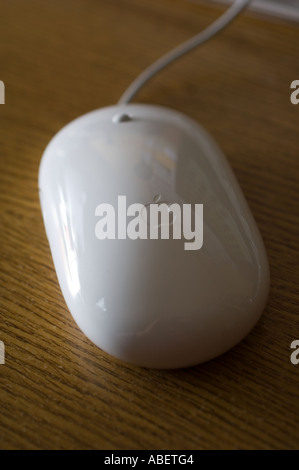 An Apple Mighty Mouse on a wooden desktop Stock Photo